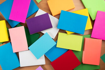 Book background. Many colorful books create texture for design. Concept of library, children's literature, textbooks for teenagers.