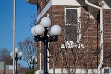Corner of an historic brick building with a black lamppost