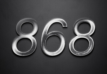 Chrome metal 3D number design of 868 on grey background.