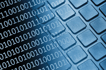 Binary code overlay on a computer keyboard. Digital technology and cybersecurity concept. Data flow background. Internet communication texture. Software coding in a modern business environment.