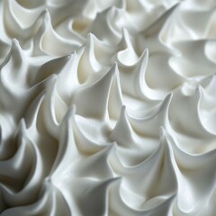 Fototapeta premium Macro shot of stiff, glossy whipped egg whites with intricate peaks and delicate folds.