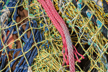 full frame photo of back nets, colored balls and cables used in professional fishing