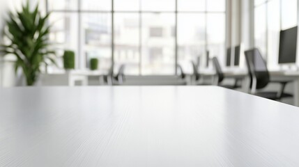 Sleek white rectangular wooden table with natural lighting and blurred modern office background featuring desks and computers
