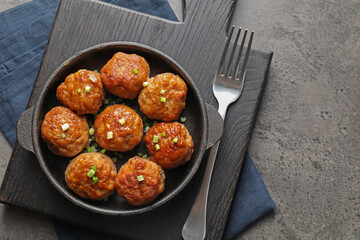 Tasty meatballs served on grey table, flat lay