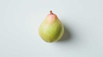 A green pear sits on a white background