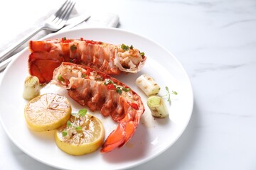 Delicious lobster tails with lemon, microgreens and green onion on white marble table, closeup