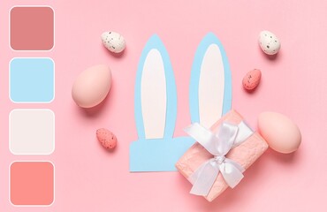 Paper bunny ears with Easter eggs and gift on pink background. Different color patterns