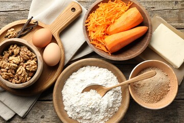 Different ingredients for making carrot cake on wooden table, flat lay
