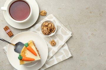 Piece of delicious homemade carrot cake served on light grey table, flat lay. Space for text