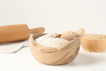 Brown rice and flour on white table, closeup. Space for text