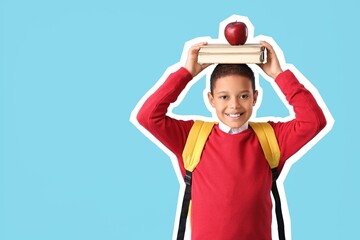 African-American schoolboy with books and apple on light blue background