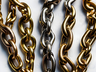 Obraz premium Gold and Silver Chains Intertwined: A close-up image showcasing the contrast and intricate details of gold and silver chains, intertwined and forming a beautiful pattern.