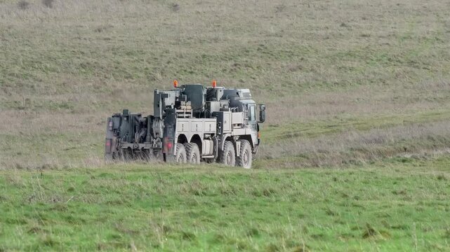 British army MAN HX SVR (Support Vehicle Recovery) 8x8 moving along a dirt track