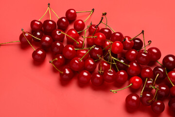 Many red sweet cherries on color background