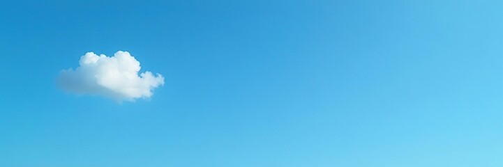 Fototapeta premium A solitary cloud drifts lazily across a clear blue sky, sky, light, tranquility