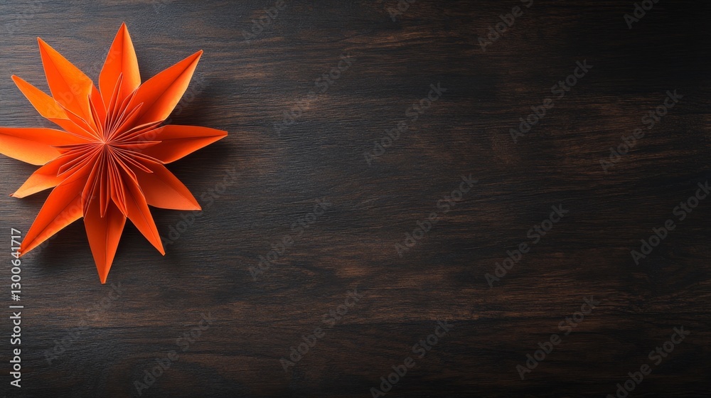Poster a vibrant orange paper star displays sharp folds on a dark wooden background, adding a cheerful touc