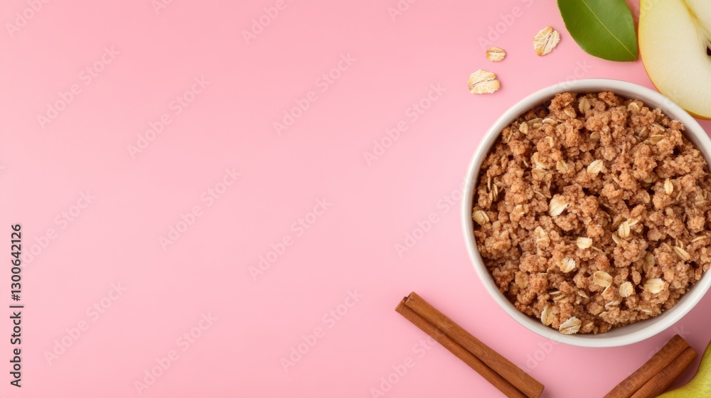 Poster crumble dish features a blend of oats and pear served in a white ceramic bowl with cinnamon sticks a