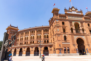 Obraz premium Las Ventas bullring, Madrid, Bull square. Plaza de toros. Events and traditions of Spain. Red sand under a burning sun. No people. Fight between matador and bull. Blood, passion, dance, celebration.