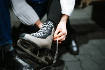 Fototapeta premium Preparing for a fun skating session on the ice rink during winter