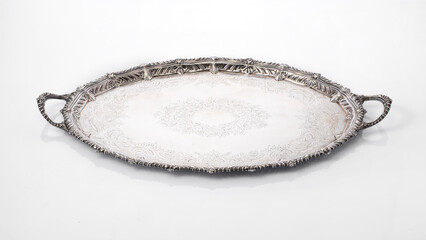antique tray worked in silver on white background with reflection