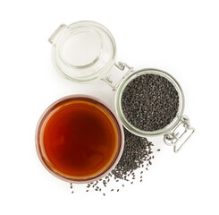 Glass of oil with jar and sesame seeds on white background