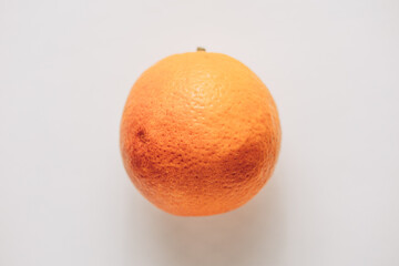 The image displays a juicy half of an orange with a vibrant, detailed texture