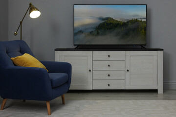 TV set with mountain landscape on screen in room