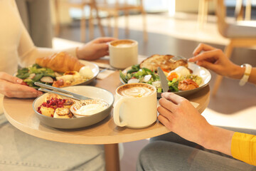 Women having tasty breakfast in cafe, closeup