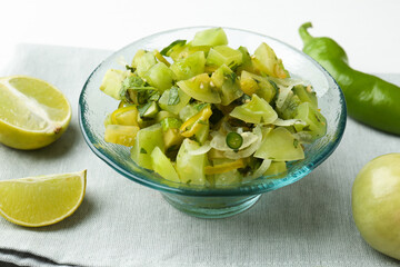 Delicious salsa (Pico de gallo) in bowl and products on white table, closeup