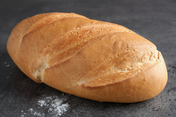 Freshly baked bread on grey table, closeup