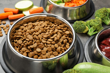 Dry pet food and natural products on grey table, closeup