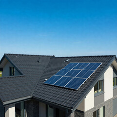 Modern house with blue solar panels on the roof. End of the day, sunset. Idyllic atmosphere