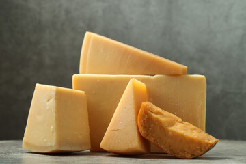 Different types of cheese on grey table