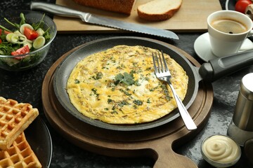 Tasty food served for brunch on black table