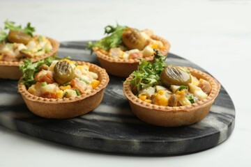 Tartlets with delicious filling on white table, closeup