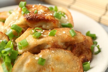 Tasty fried gyoza (dumplings) on table, closeup