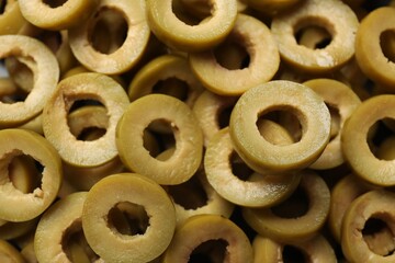 Marinated green olive rings as background, top view