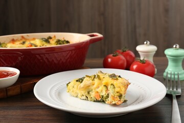 Piece of tasty vegetable casserole on wooden table, closeup