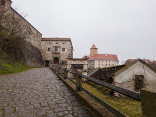 Fototapeta premium Brno, Czech Republic - January 25, 2025: View of Veveří Castle - a royal castle, a monument of medieval architecture, on a wooded cape near the Brno Reservoir, at a sharp bend in the Svratka River