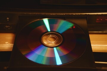 Colorful Compact Disc in Open Tray Drive in Warm Light