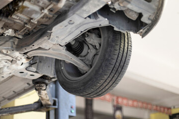 Auto mechanic working on car engine in his mechanic garage. Repair service. close up