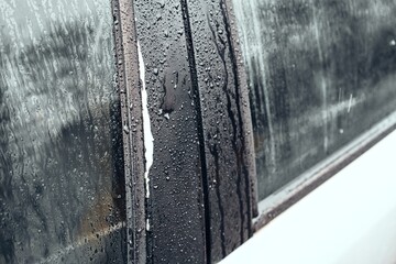 Raindrops on Car Window During a Gloomy Day