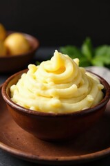 Fluffy mashed potatoes, creamy texture, rustic brown bowl , creamy, high-resolution