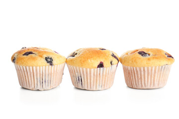 Tasty blueberry muffins on white background, closeup