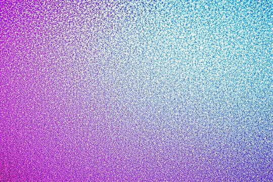 Neon purple to blue gradient rough textured glitter effect background.