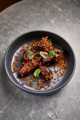 Deliciously Glazed Pork Ribs in Soy Marinade with Fried Rice Toppings Serve in Dark Bowl, Culinary Delight, Savory Meal, Elegant Dining Experience Concept