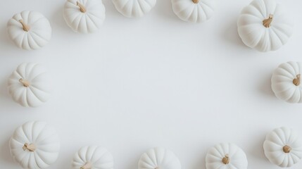 White pumpkins arranged in a circle on a white background. (1)