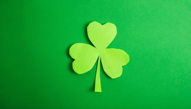 a close-up shot of a handcrafted green shamrock on a contrasting background. The shamrock is a symbol of good luck and is commonly associated with St. Patrick's Day