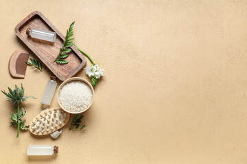 Composition with bottles of rice water, grains, massage brush and plants on color background