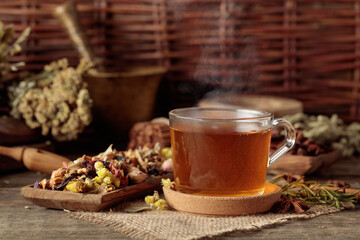Cup of herbal tea with various dried herbs, flowers, and spices.